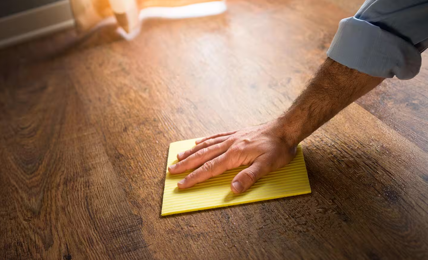Man Washing Hardwood Flooring by Hand